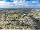 Aerial view of a community featuring single-Gathering homes near a scenic river and lush landscapes at 22062 Marshall Ave, Port Charlotte, FL 33952