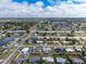 Wide aerial view of a neighborhood with single-Gathering homes, tree-lined streets, and lush greenery at 22062 Marshall Ave, Port Charlotte, FL 33952