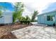 Backyard with an outdoor shed and patio area, complemented by neatly trimmed hedges and lush greenery at 22062 Marshall Ave, Port Charlotte, FL 33952
