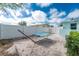 Relaxing backyard featuring a blue and white striped hammock, white privacy fence, and ample space for outdoor enjoyment at 22062 Marshall Ave, Port Charlotte, FL 33952