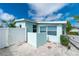 Backyard featuring a privacy fence, turquoise painted home and tropical landscaping at 22062 Marshall Ave, Port Charlotte, FL 33952