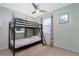 Cozy bedroom features a bunk bed, tile flooring, and natural light at 22062 Marshall Ave, Port Charlotte, FL 33952