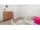 Cozy bedroom featuring a vintage dresser, tiled floor and white walls at 22062 Marshall Ave, Port Charlotte, FL 33952