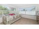 Bedroom with tile floors, dresser, and large window with blinds at 22062 Marshall Ave, Port Charlotte, FL 33952