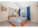 Bedroom with tile floors, ceiling fan, dresser, mirror, and curtains at 22062 Marshall Ave, Port Charlotte, FL 33952