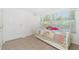 Bedroom with tile floors, overhead lighting, and large bright window with blinds at 22062 Marshall Ave, Port Charlotte, FL 33952