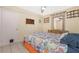 Bedroom with tile flooring, overhead ceiling fan, side tables, and decorations at 22062 Marshall Ave, Port Charlotte, FL 33952