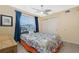 Bedroom featuring tile floors, large closet, ceiling fan and blue curtains at 22062 Marshall Ave, Port Charlotte, FL 33952