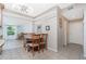 Cozy dining area adjacent to the kitchen, featuring a stylish ceiling fan and a round table for meals at 22062 Marshall Ave, Port Charlotte, FL 33952