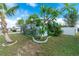 Charming home featuring a lush lawn, plumeria tree and privacy fence at 22062 Marshall Ave, Port Charlotte, FL 33952