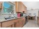 Well-lit kitchen with stone countertops, stainless steel appliances, mosaic backsplash, and natural wood cabinets at 22062 Marshall Ave, Port Charlotte, FL 33952