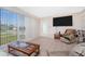Bright living room with large windows and tile flooring, offering comfortable seating and natural light at 22062 Marshall Ave, Port Charlotte, FL 33952