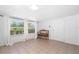 Sunlit living room with tile floors, bench, and ample natural light at 22062 Marshall Ave, Port Charlotte, FL 33952