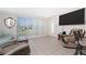 Inviting living room featuring tile flooring, a large window, and a comfortable seating arrangement at 22062 Marshall Ave, Port Charlotte, FL 33952