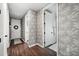 Modern hallway with hardwood floors, stylish wallpaper, and access to multiple rooms at 43789 Cattleman Dr, Punta Gorda, FL 33982