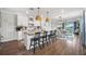 Open concept kitchen with island seating, hardwood floors, and white cabinetry at 43789 Cattleman Dr, Punta Gorda, FL 33982