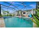 Refreshing pool and spa with a screened enclosure and lounge area at 43789 Cattleman Dr, Punta Gorda, FL 33982