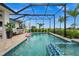 Refreshing pool and spa with a screened enclosure and lounge area at 43789 Cattleman Dr, Punta Gorda, FL 33982