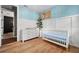 Bright Bedroom with white furniture, hardwood floors, and a view of another room at 43789 Cattleman Dr, Punta Gorda, FL 33982