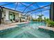 Inviting pool and spa with a screened enclosure and lounge area at 43789 Cattleman Dr, Punta Gorda, FL 33982