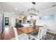 Bright dining area features a wooden table, white chairs, and kitchen views at 43789 Cattleman Dr, Punta Gorda, FL 33982