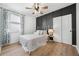 Bright bedroom with a queen bed, light flooring, and dark accent wall at 43789 Cattleman Dr, Punta Gorda, FL 33982