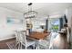 Farmhouse dining room with a rustic wooden table and white chairs at 43789 Cattleman Dr, Punta Gorda, FL 33982