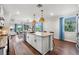 Bright kitchen boasts an expansive island, hardwood floors and white shaker cabinets at 43789 Cattleman Dr, Punta Gorda, FL 33982