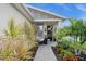 Front entrance with a walkway and lush landscaping at 43789 Cattleman Dr, Punta Gorda, FL 33982