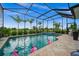 Screened-in pool and spa with a view of lush landscaping at 43789 Cattleman Dr, Punta Gorda, FL 33982