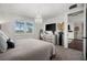 Spacious bedroom with large windows, plush bedding, and a view of another room at 43789 Cattleman Dr, Punta Gorda, FL 33982