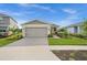 Craftsman style home with a landscaped yard at 43789 Cattleman Dr, Punta Gorda, FL 33982
