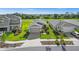 Aerial view of a new home community with multiple houses and green spaces at 43789 Cattleman Dr, Punta Gorda, FL 33982