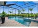 Inviting pool and spa with a screened enclosure and a beautiful view at 43789 Cattleman Dr, Punta Gorda, FL 33982
