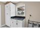 Bright laundry room with white cabinets and granite countertop at 2309 Conway Blvd, Port Charlotte, FL 33952