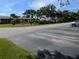 Parking lot view with community pool and buildings at 1515 Forrest Nelson Blvd # E106, Port Charlotte, FL 33952