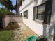 Building exterior with gravel landscaping and green grass at 1515 Forrest Nelson Blvd # E106, Port Charlotte, FL 33952