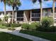 Two-story building exterior with landscaping and walkway at 1515 Forrest Nelson Blvd # E106, Port Charlotte, FL 33952