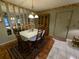 Bright dining room featuring a wooden table and hardwood floors at 1515 Forrest Nelson Blvd # E106, Port Charlotte, FL 33952