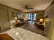 Living room with sofa, chairs, and access to patio at 1515 Forrest Nelson Blvd # E106, Port Charlotte, FL 33952