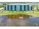 Condo building overlooking a tranquil pond, offering serene waterfront views at 14121 Heritage Landing Blvd # 731, Punta Gorda, FL 33955