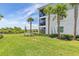 Landscaped backyard with water view and palm trees at 14121 Heritage Landing Blvd # 731, Punta Gorda, FL 33955