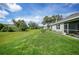 Large backyard with grassy area and partially visible house at 27441 Natal Dr, Punta Gorda, FL 33983