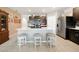Modern kitchen with island and seating, stainless steel appliances and dark cabinetry at 27441 Natal Dr, Punta Gorda, FL 33983