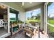 Relaxing screened porch with wicker furniture and garden at 27441 Natal Dr, Punta Gorda, FL 33983