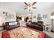 Spacious living room with two leather couches and a view of kitchen and dining areas at 27441 Natal Dr, Punta Gorda, FL 33983
