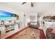 Bright living room features a large TV, comfortable seating, and decorative accents at 27441 Natal Dr, Punta Gorda, FL 33983
