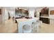 Modern kitchen with island, seating, stainless steel appliances and dark cabinetry at 27441 Natal Dr, Punta Gorda, FL 33983