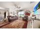 Cozy living room featuring a brown leather couch and large TV at 27441 Natal Dr, Punta Gorda, FL 33983