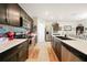 Modern kitchen featuring dark cabinetry, stainless steel appliances, and quartz countertops at 27441 Natal Dr, Punta Gorda, FL 33983